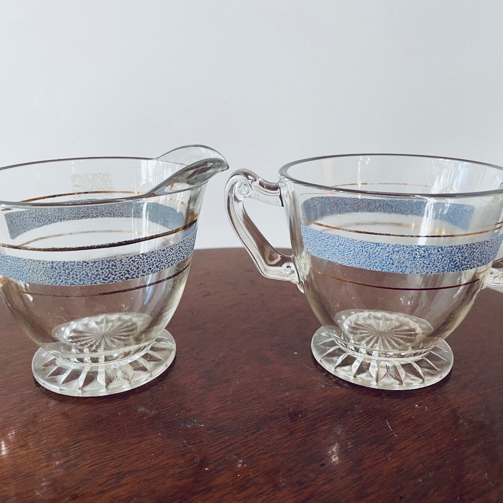 Vintage clear glass creamer and sugar set with blue and gold band